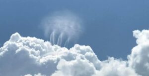 mysterious tornado like clouds form above cumulus cloud in Alabama
