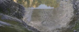 mysterious crop circle appears at bottom of draining lake