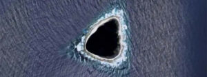 unusual island that looks like a black hole spotted on google maps